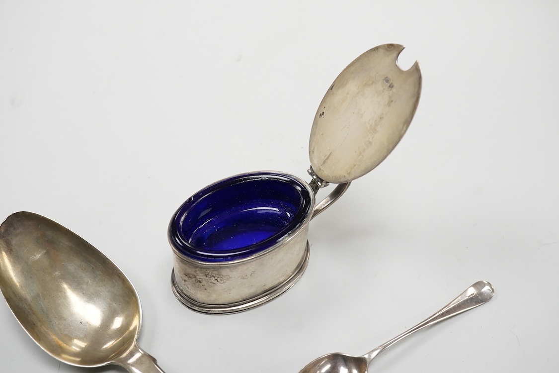 A William IV silver fiddle pattern table spoon by Richard Britton, London, 1834, together with a George V silver oval mustard pot, with blue glass liner, Edward Barnard Sons Ltd, London, 1931 and a silver coffee spoon.